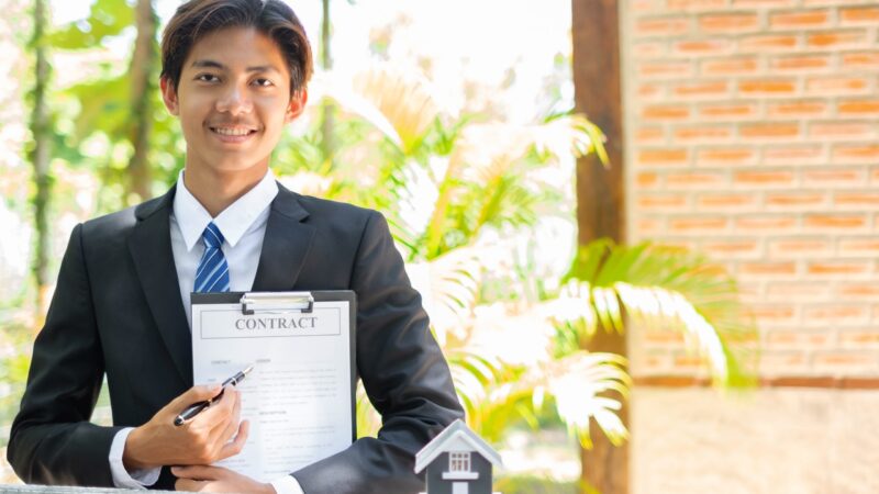 Home Insurance Concept And Real Estate. Business Asian Man With