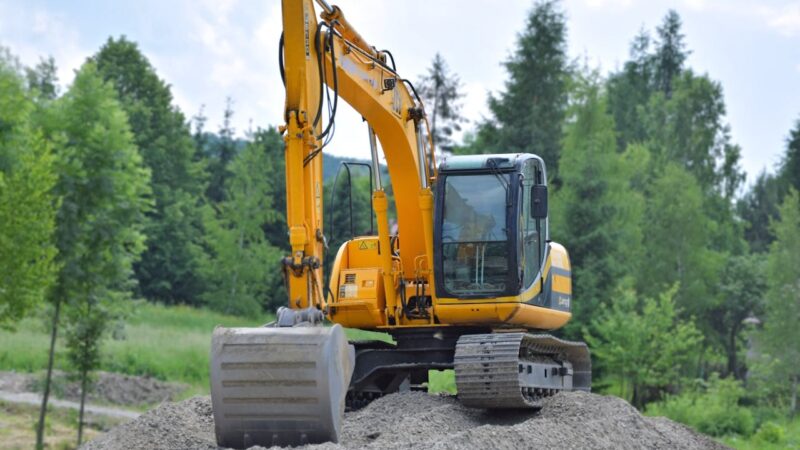 Yellow excavator at a construction site - excavation advertising ideas