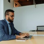 Focused businessman working on laptop — Filipino virtual assistant supporting US business