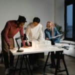 Diverse team collaborating on architectural project with scale model