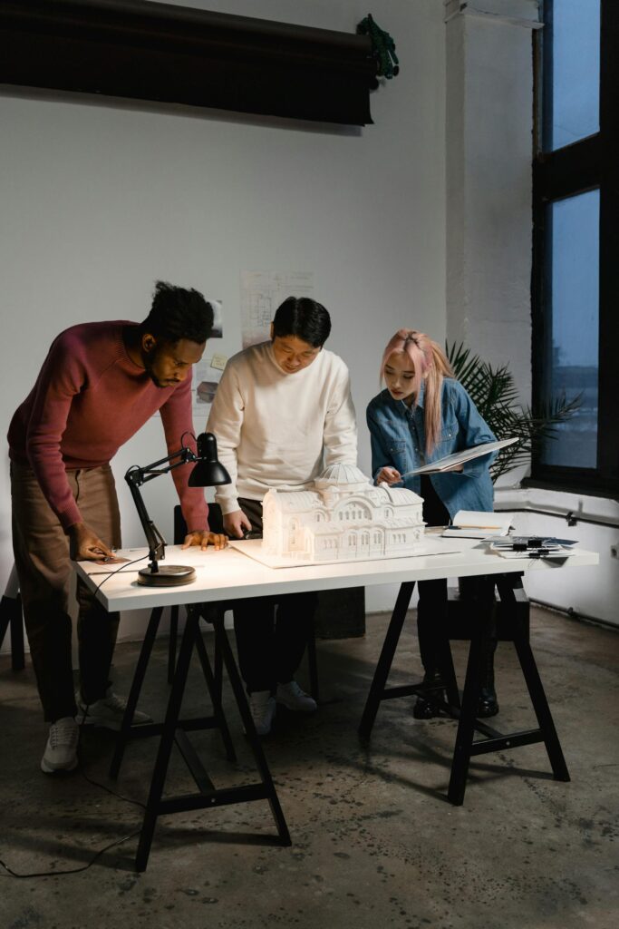 Diverse team collaborating on architectural project with scale model