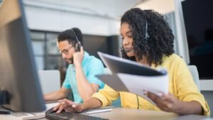 Two BPO representatives working together at a contact center