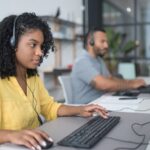 Call center agents with headsets handling customer support calls