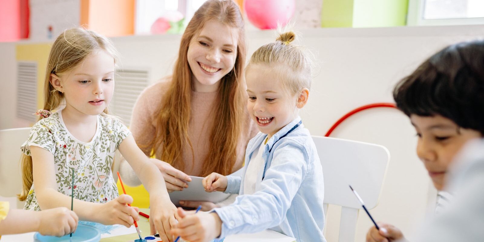 Teacher reading to young children in a classroom
