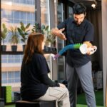 Chiropractor demonstrating with spine model