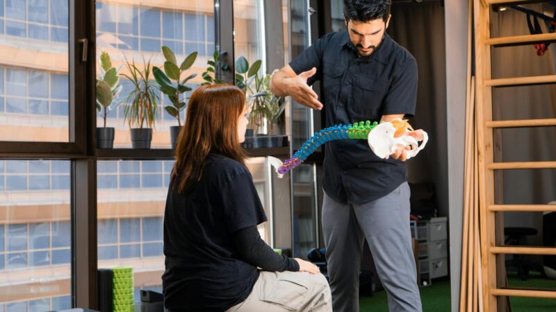 Chiropractor demonstrating with spine model