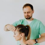 Therapist performing neck adjustment