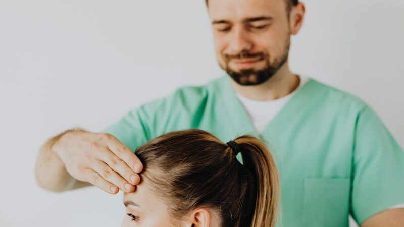 Therapist performing neck adjustment