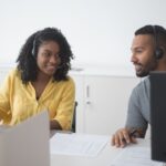 Manager reviewing a contact center outsourcing provider with a colleague