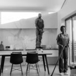 Professional cleaners working in modern dining room