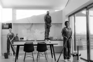 Professional cleaners working in modern dining room