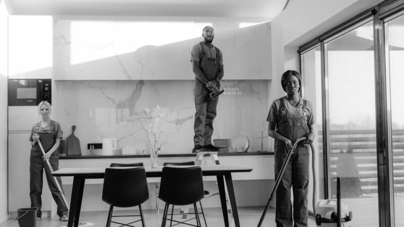 Professional cleaners working in modern dining room