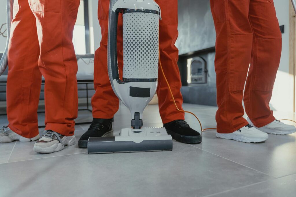 Cleaning crew vacuuming residential interior
