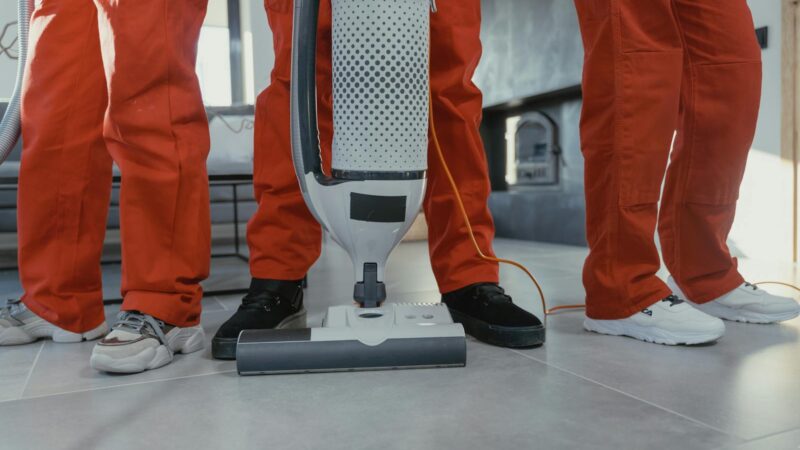 Cleaning crew vacuuming residential interior