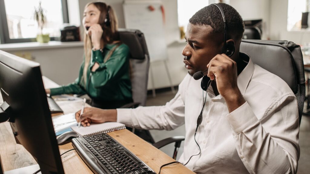 Call center agent with a headset handling inbound and outbound calls
