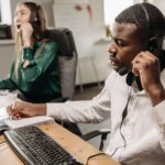 Call center agent with a headset handling inbound and outbound calls
