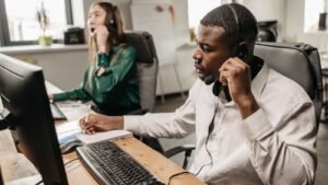 Call center agent with a headset handling inbound and outbound calls