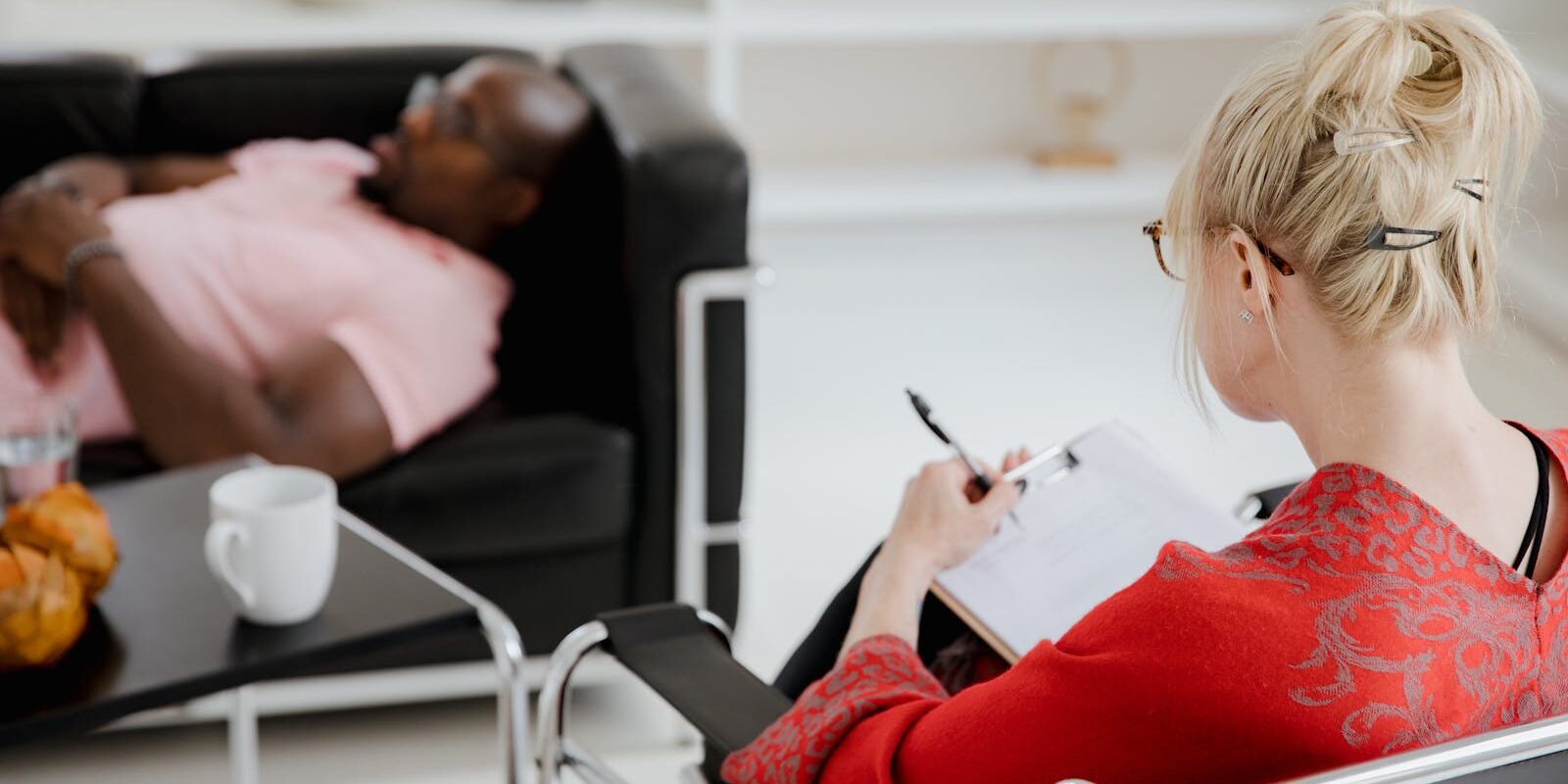 Therapist taking notes during a counseling session