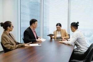 Diverse team of professionals comparing options in a boardroom meeting