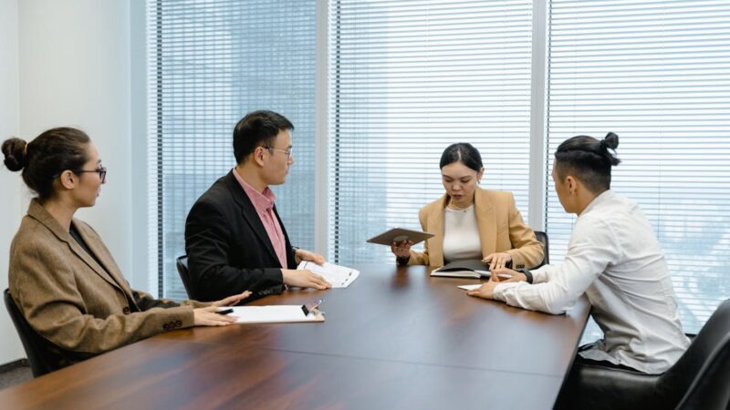 Diverse team of professionals comparing options in a boardroom meeting