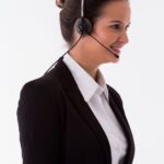 A telemarketing agent wearing a headset making outbound calls
