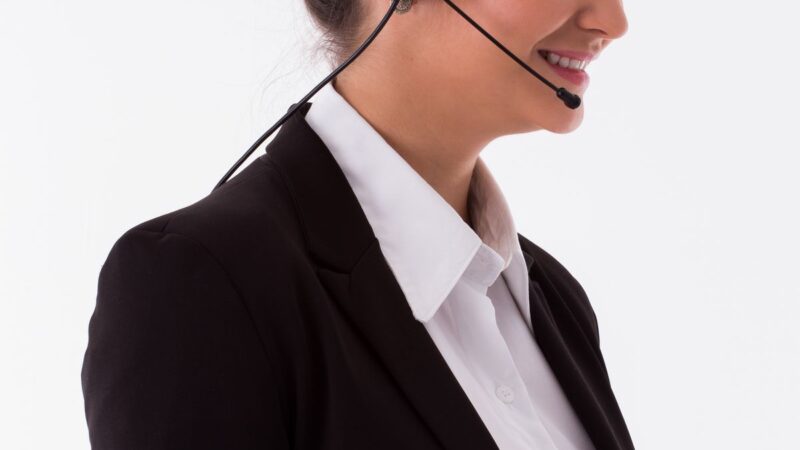 A telemarketing agent wearing a headset making outbound calls