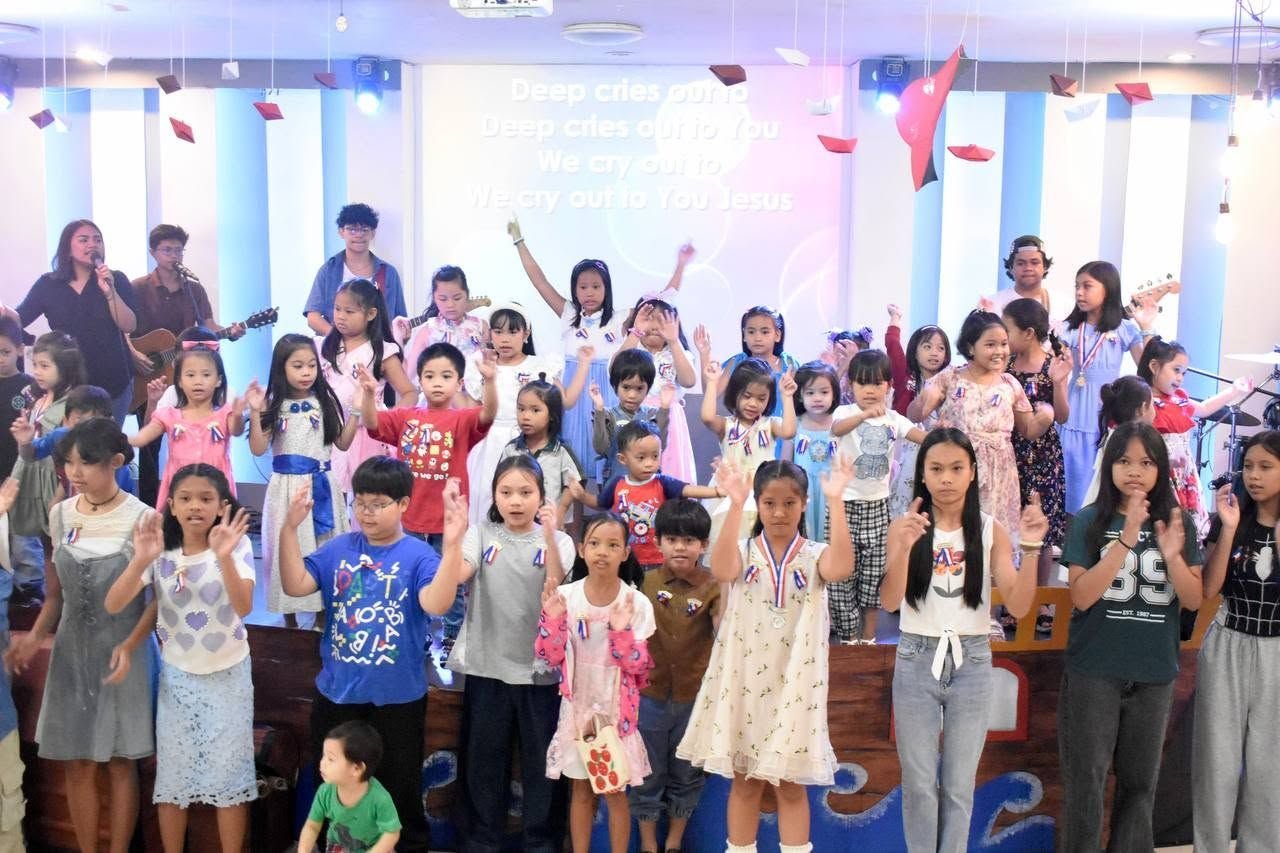 Children on stage with the worship band at the DVBS 2026 closing
