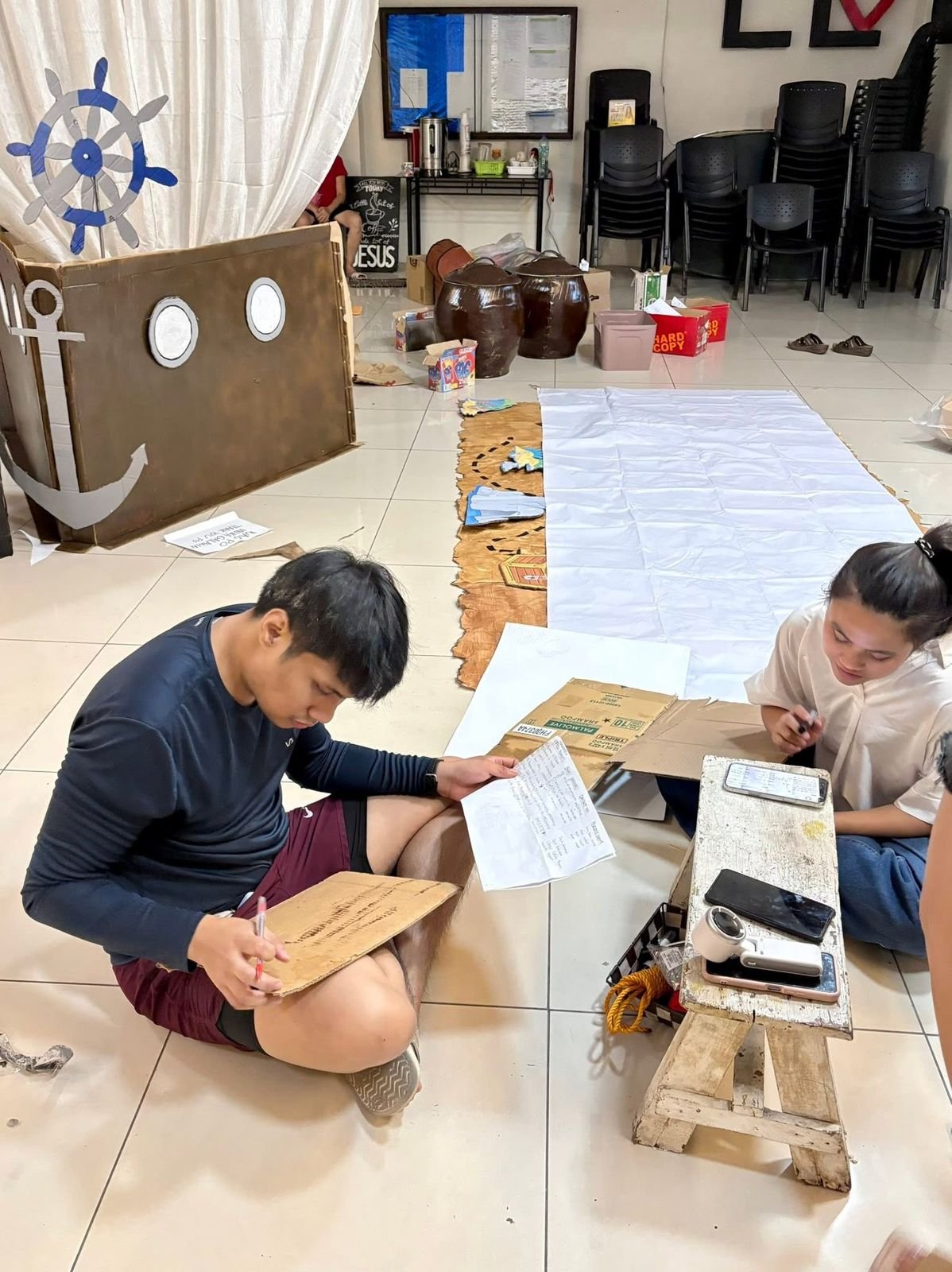 Volunteers building the cardboard pirate ship set for DVBS 2026