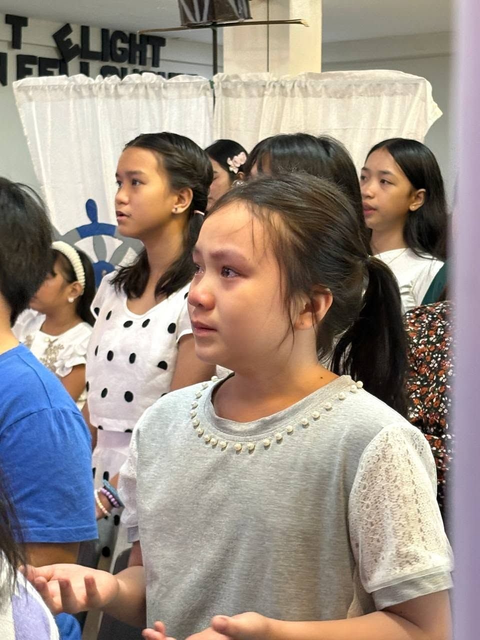 A young girl moved during worship at DVBS 2026