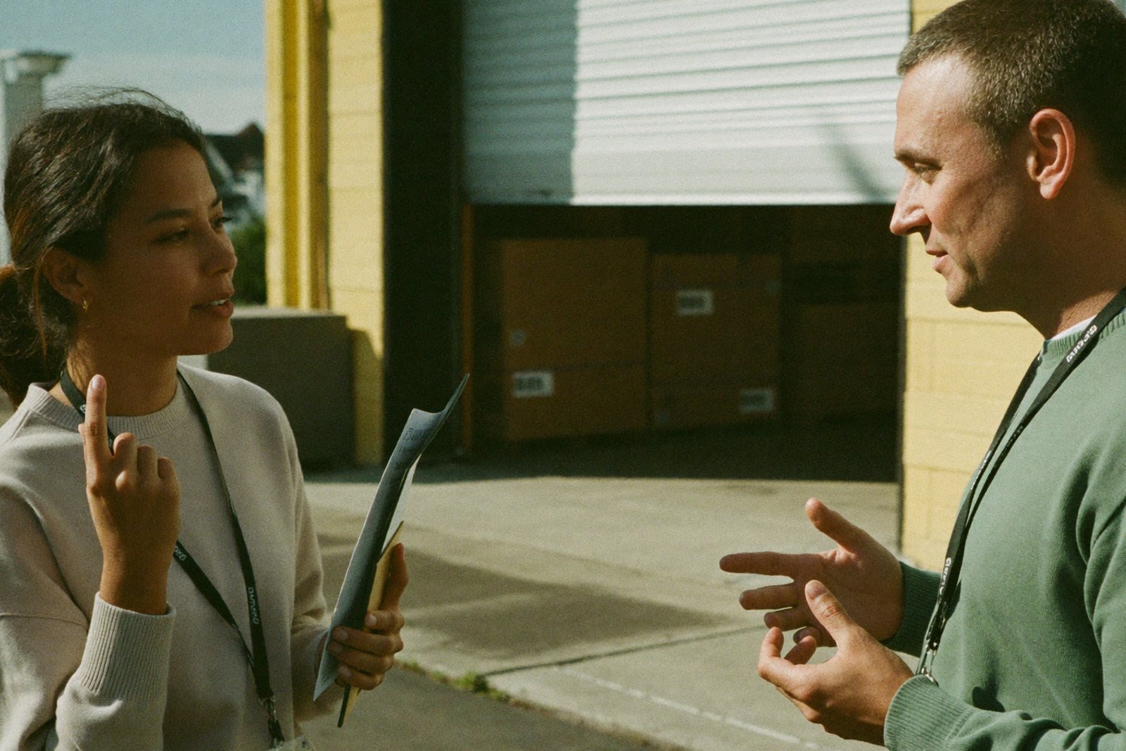 Two online store owners comparing vendor options in a small bright warehouse office