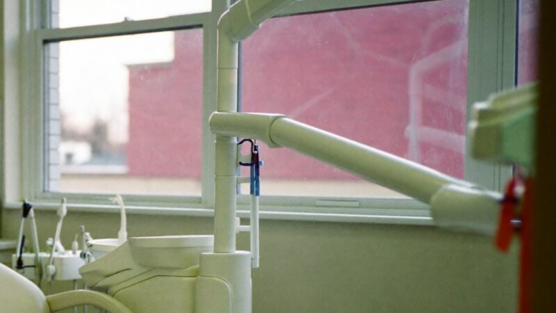 Empty dental operatory chair by a bright window, representing dental virtual assistant companies