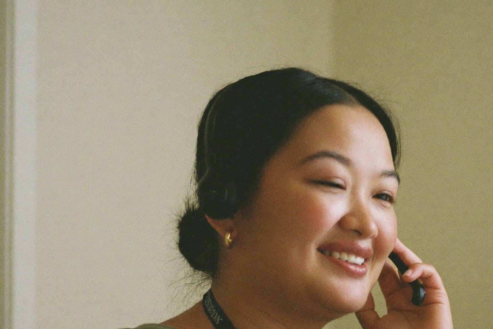 Remote dental virtual assistant wearing a headset on a patient call from a home office