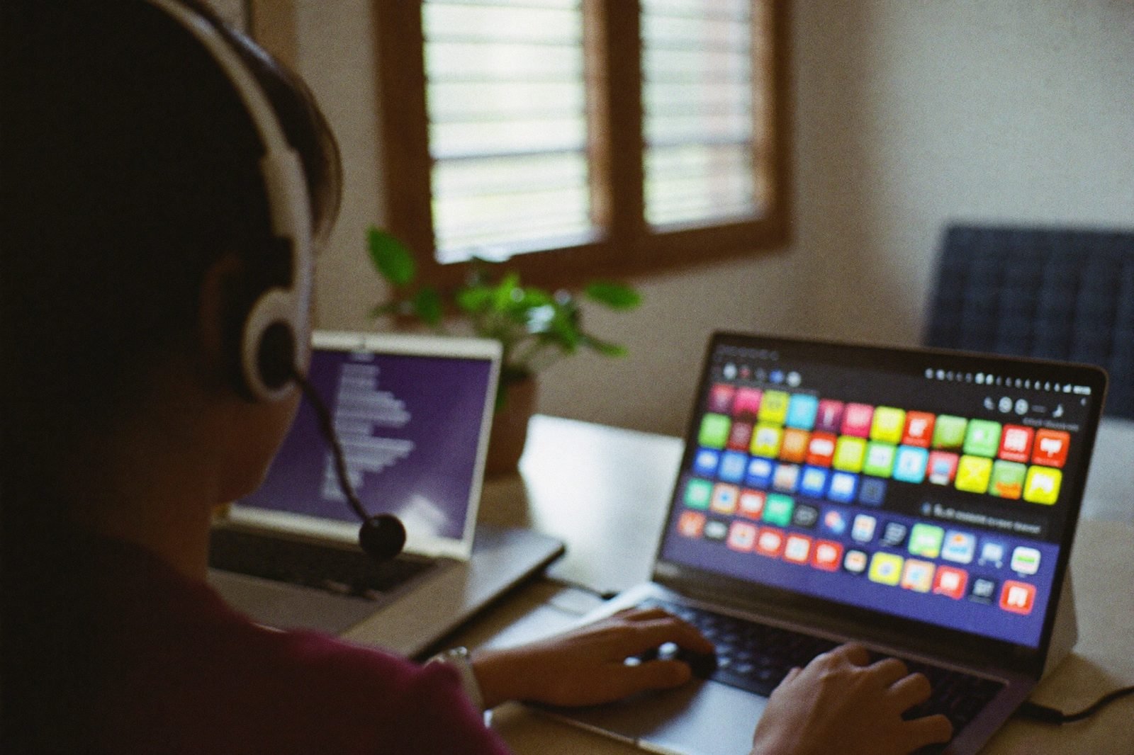 Remote GoHighLevel virtual assistant working across two screens with a colorful dashboard