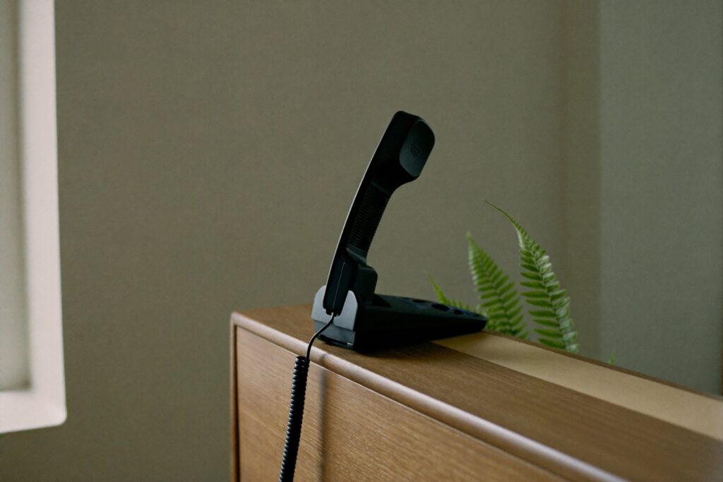 Desk telephone handset on a reception counter, best answering services for small business