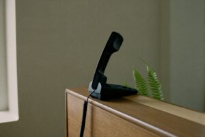 Desk telephone handset on a reception counter, best answering services for small business