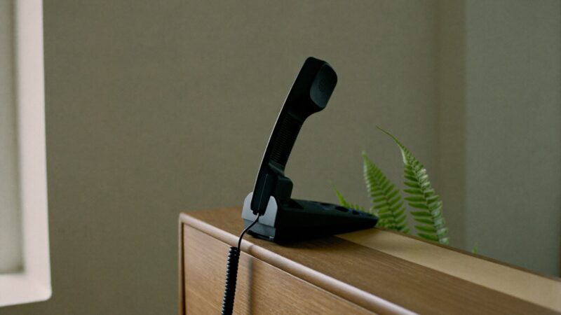 Desk telephone handset on a reception counter, best answering services for small business